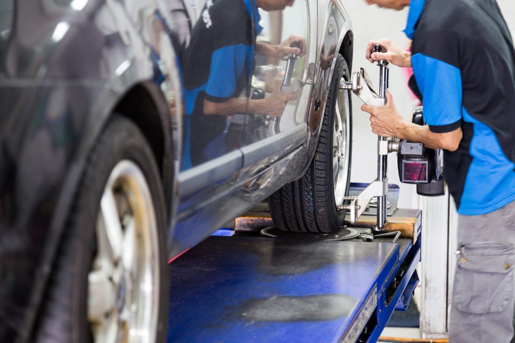 Mechanic fixing tire alignment